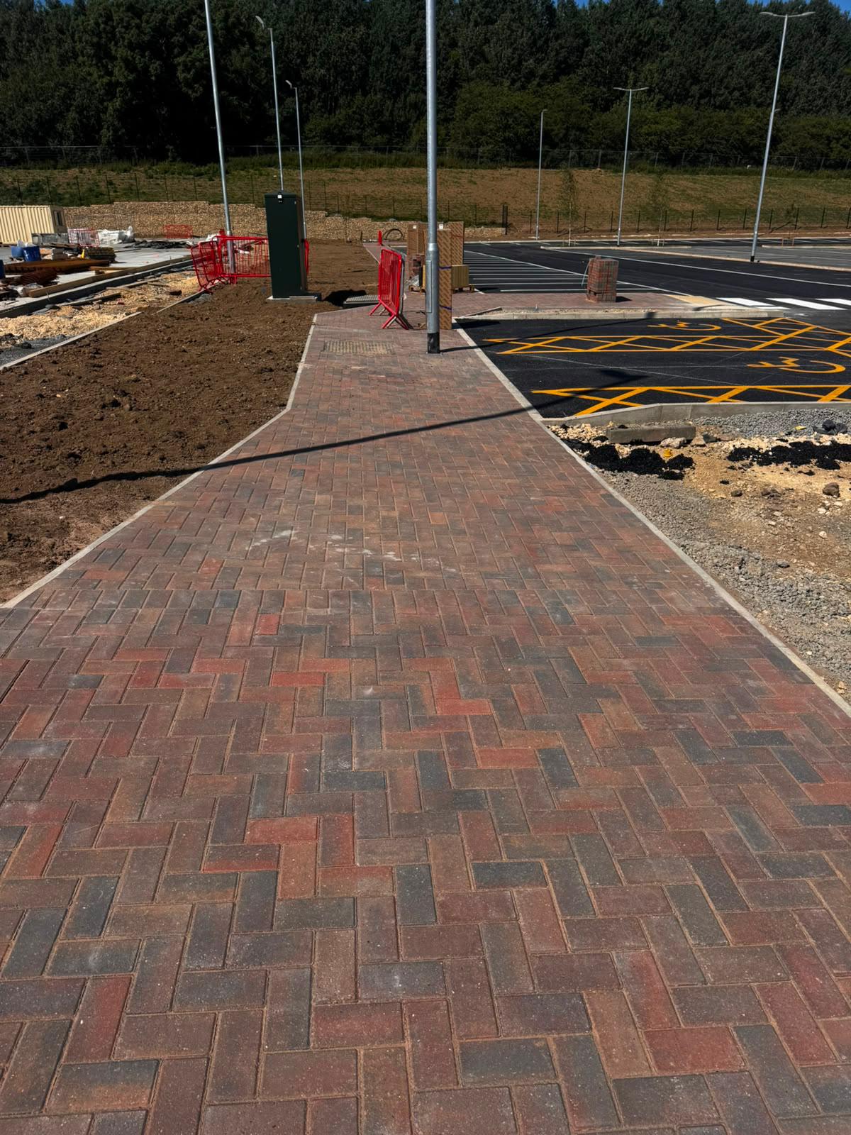 Completed block paved pathway beside accessible parking